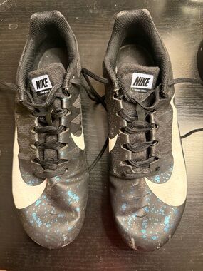 Nike Zoom rival s track spikes with White Swoosh and Blue Splash.